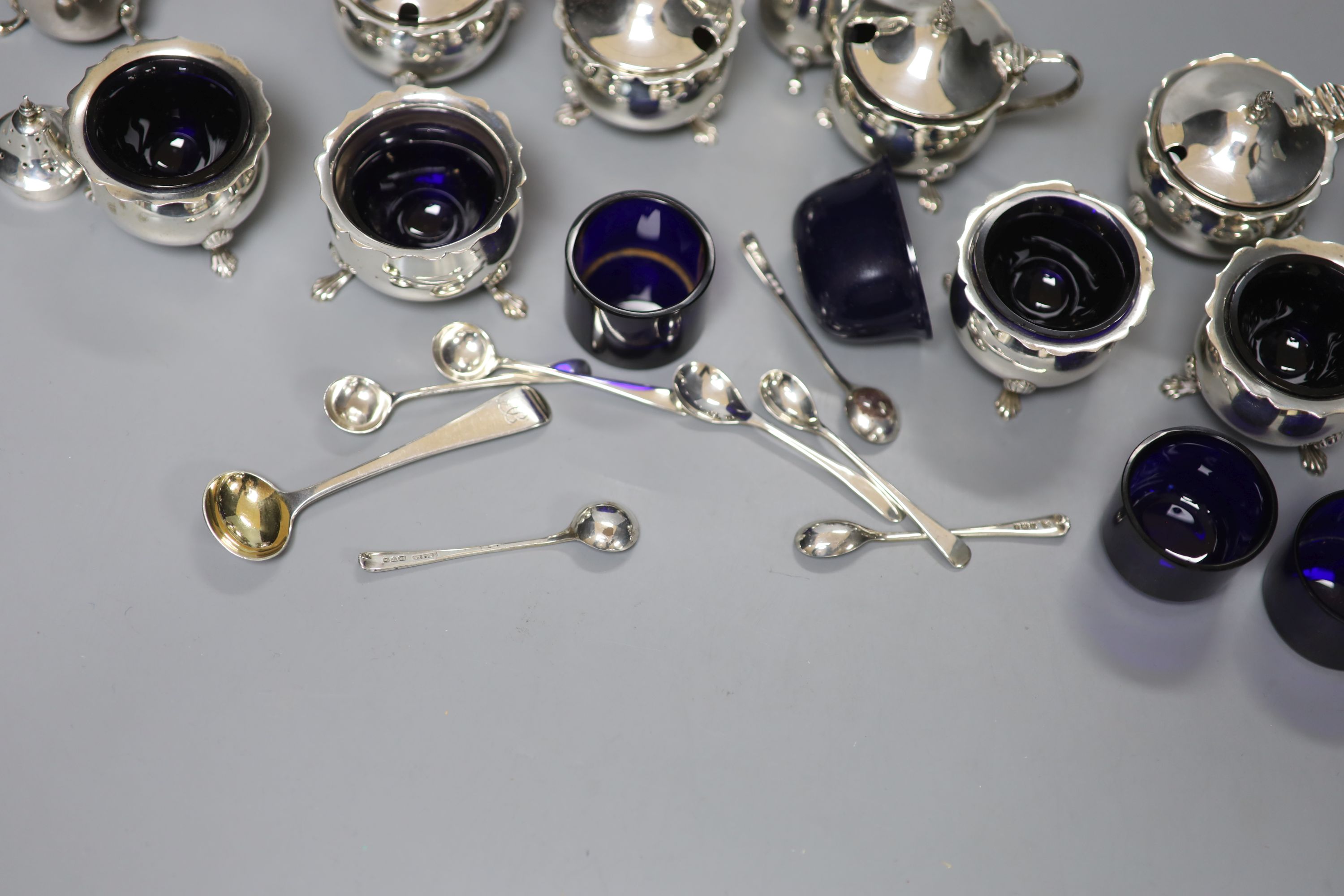 An Edwardian six piece silver condiment set and five other assorted silver condiments.